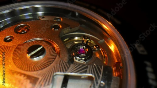 Macro close-up of a luxury mechanical watch movement with a visible ruby jewel and golden reflections. Precision engineering, craftsmanship, and premium horology design.