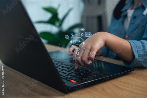 Close up girl hand using laptop with virtual AI chatbot robot. Concept of artificial intelligence, machine learning assistant, automation, and future technology.