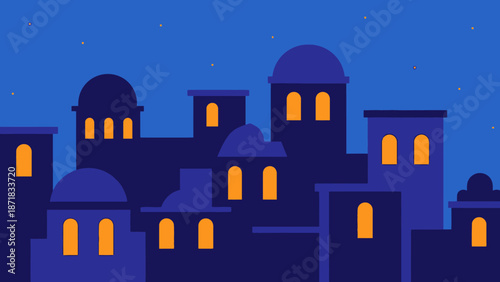 Silhouette of buildings with illuminated windows against a blue night sky.