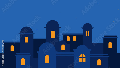 Silhouette of a building complex with illuminated windows at dusk.