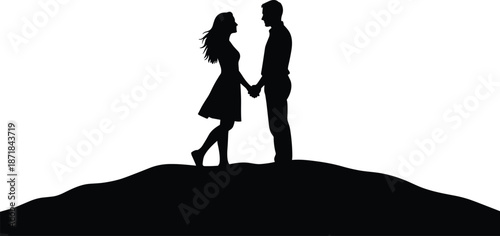 Silhouette of a man and woman holding hands on a hilltop