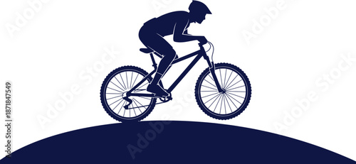 Silhouette of a person riding a mountain bike on a hill