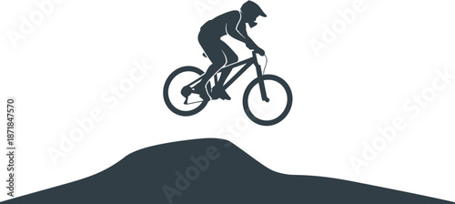 Silhouette of a mountain biker performing a jump on a dirt track, emphasizing speed and extreme sport