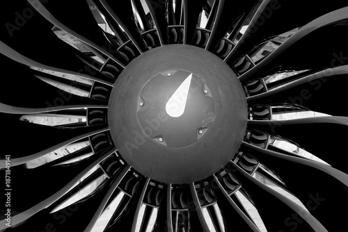 Black and white close-up of an airplane engine. Turbine and blades visible