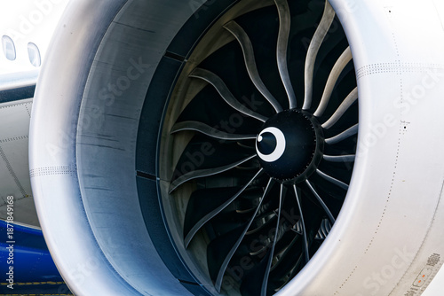 Black and white close-up of an airplane engine. Turbine and blades visible of Boeing 777