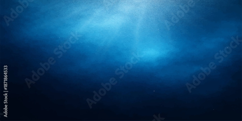 An underwater world loop background creates a deep blue ocean scene with bright nature light rays piercing through a dark sea texture backdrop to form a serene design
