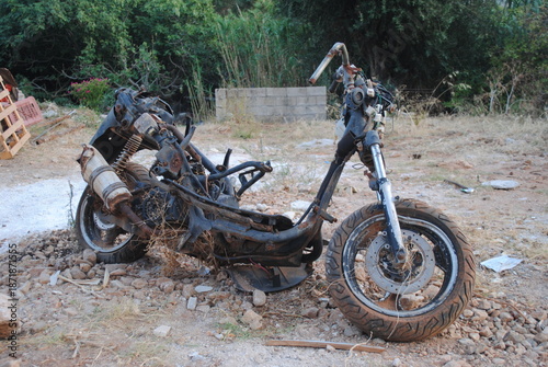 Abandoned Motorcycle Frame in Overgrown Field - Rusting Vehicle Parts, Neglect, Decay, Rural Landscape