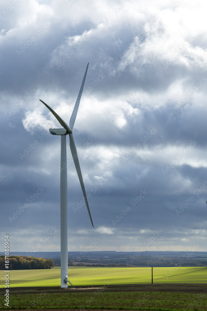 Fototapeta premium Wind turbine generating clean energy in rural France