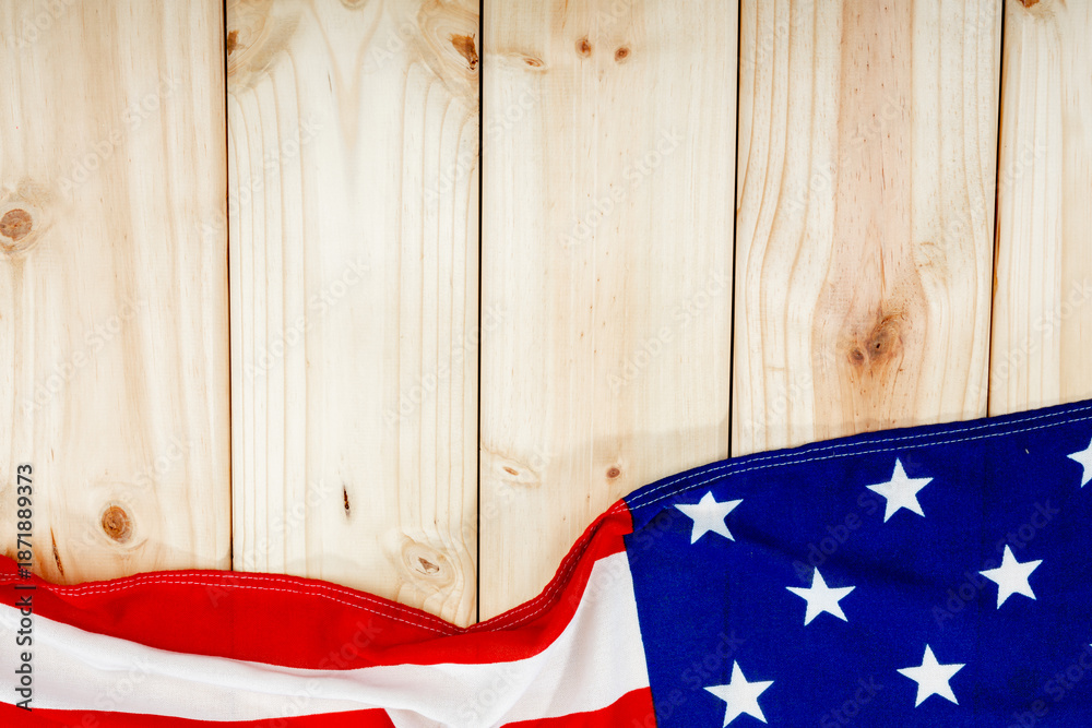 Fototapeta premium Directly above view of america flag with stars and stripes on wooden table with copy space