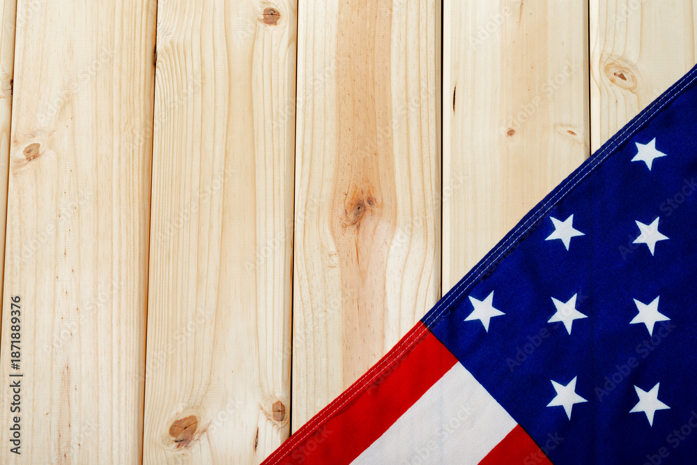 Fototapeta premium Stars with red and white stripes on america flag flattened over wooden table with copy space