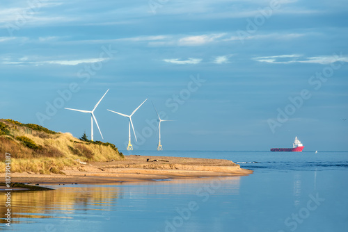 Offshore wind turbine farm, offshore supply vessel and Don River Delta on Scotland coast of Aberdeen, UK