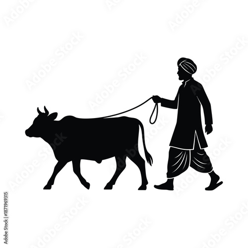 A silhouette of a farmer leading a cow along a path a classic rural scene