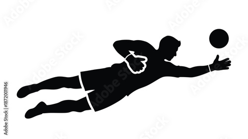 A silhouette of a goalkeeper diving to save a soccer ball in action