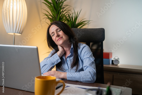 Tableau sur toile Tired business woman with neck pain looking uncomfortable while working with computer in the office
