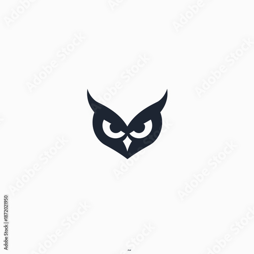 Minimalist abstract dark owl head icon with piercing eyes. Vector silhouette illustration of a wise nocturnal bird face on white.