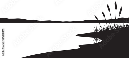 Serene lake silhouette at sunset with cattails and hills