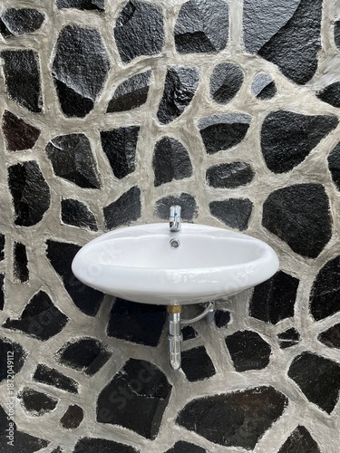 Modern White Sink on Rock Wall