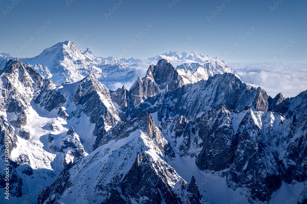 Fototapeta premium Sharp peaks in the Alps in winter, Chamonix-Mont-Blanc. Snow-covered mountains in Europe. Breathtaking mountain landscapes.