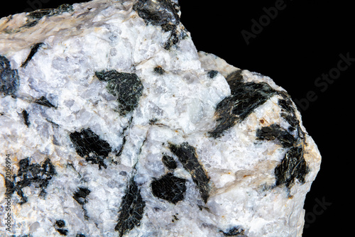 Pegmatite granite with large biotite mica crystals. From burrow creek, Arizona. Black background.
