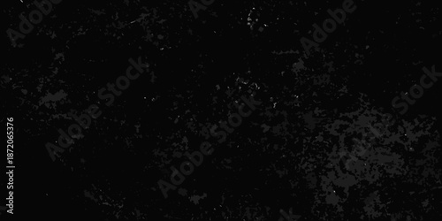 A dark almost entirely black image with subtle grainy texture and minimal light