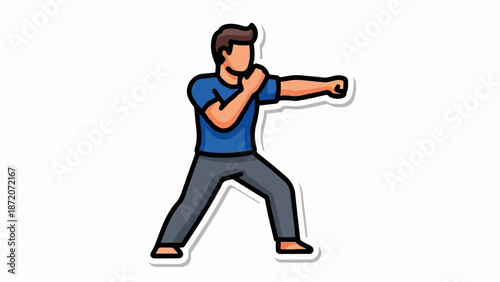 A man in a blue shirt and gray pants practices a martial arts stance