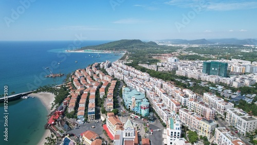 Wallpaper Mural Phu Quoc, Sunset Town, Vietnam. 4k high-quality footage taken with a Drone showcasing colorful buildings, blue skies, a watch tower, a kissing bridge, turquoise clear waters, green forest, golden sand Torontodigital.ca