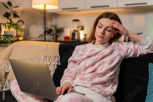 Quadro em tela Middle-aged woman at night home works late on laptop feels tired overworked stressed near burnout