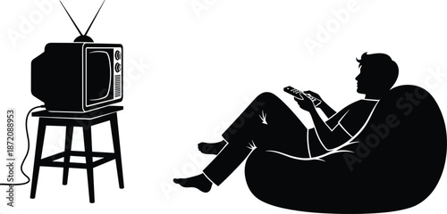Silhouette of a young man relaxing in a bean bag chair while using a remote control to watch a vintage retro television set,