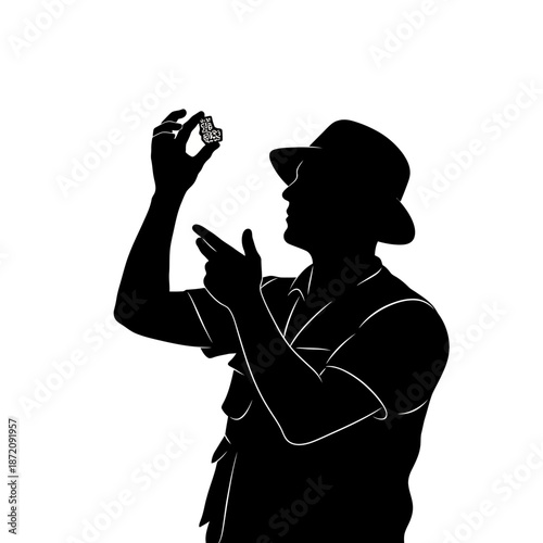 Silhouette of an explorer examining a rock sample with great interest.