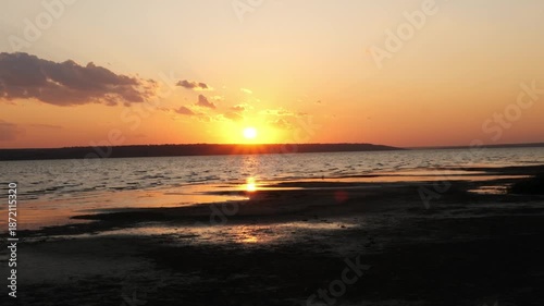 A beautiful golden sunset over a calm lake or sea