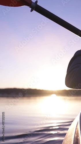 oar paddles on calm water against the background of sunset rays, outdoor activities on a kayak,