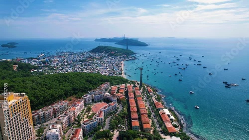 Wallpaper Mural Phu Quoc, Sunset Town, Vietnam. 4k high-quality footage taken with a Drone showcasing colorful buildings, blue skies, a watch tower, a kissing bridge, turquoise clear waters, green forest, golden sand Torontodigital.ca