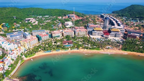 Wallpaper Mural Phu Quoc, Sunset Town, Vietnam. 4k high-quality footage taken with a Drone showcasing colorful buildings, blue skies, a watch tower, a kissing bridge, turquoise clear waters, green forest, golden sand Torontodigital.ca