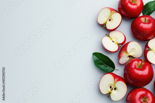Fresh red apples sliced open on light background, showcasing their juicy interior and vibrant color, perfect for healthy snacks