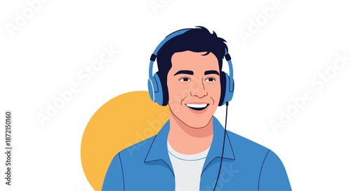 Happy young man wearing blue headphones and a denim shirt smiling while listening to music or a podcast with joy.