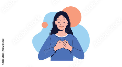 Peaceful woman with long dark hair placing hands over her heart and closing her eyes in a gesture of gratitude and inner calm.