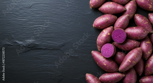 Vibrant Purple Yams and Slices Arranged on Textured Dark Slate, High Contrast Food Photography of Antioxidant Rich Vegetables