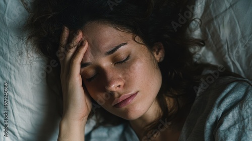 A woman unable to sleep because of a sleep condition head pain fever