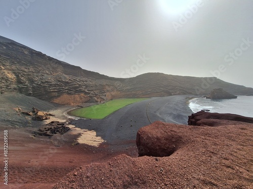 Lanzarote volcanic Lake and ocean beach in El Golfo, Canary Islands, Spain, tourism in the Canaries. Charco de los Clicos
