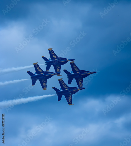 Naval Airshow, F-18 Super Hornet jets flying in formation on beautiful summer day high in the clouds