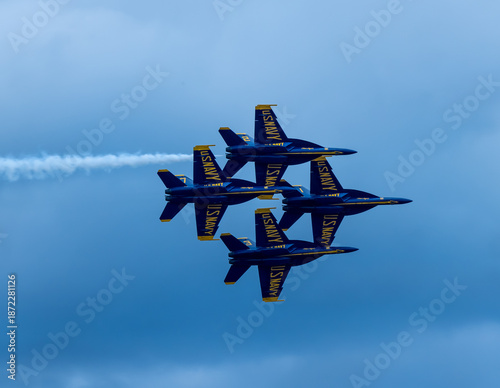 Naval Airshow, F-18 Super Hornet jets flying in formation on beautiful summer day high in the clouds