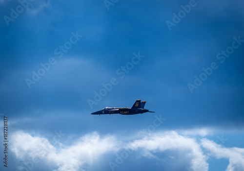 Naval Airshow, F-18 Super Hornet jets flying in formation on beautiful summer day high in the clouds