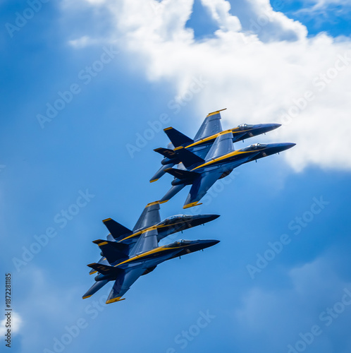 Naval Airshow, F-18 Super Hornet jets flying in formation on beautiful summer day high in the clouds