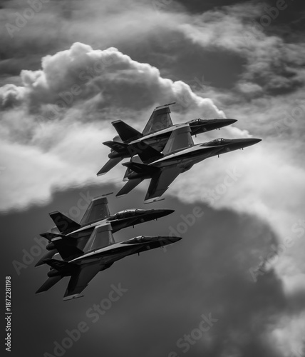 Naval Airshow, F-18 Super Hornet jets flying in formation on beautiful summer day high in the clouds