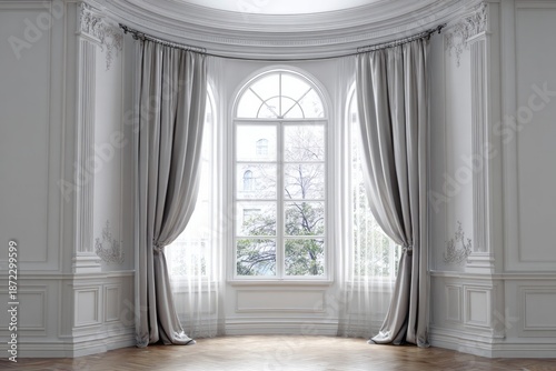 Elegant room with large arched window and grey curtains.