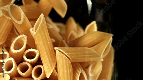 Super slow motion dry penne pasta . Filmed on a high-speed camera at 1000 fps. High quality FullHD footage