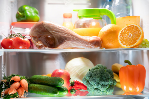 An open refrigerator door. A fridge full of healthy and wholesome food.