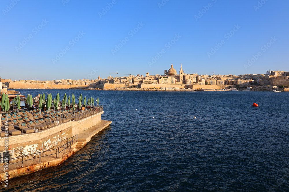 Fototapeta premium Sliema bay and the Dome of the Basilica of Our Lady of Mount Carmel and Valletta, il-Belt Valletta is the capital city of Malta and one of its 68 council areas.