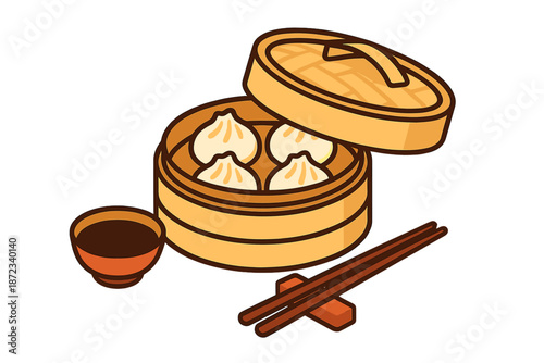 Dumplings in a bamboo steamer with a bowl of sauce and chopsticks on the side