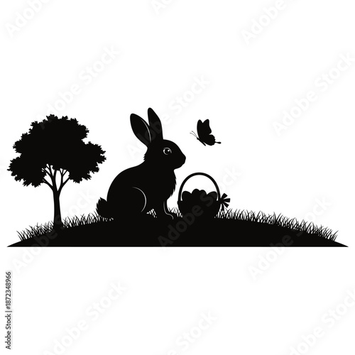Black silhouette of a rabbit with a basket and a butterfly near a tree on grass easter day